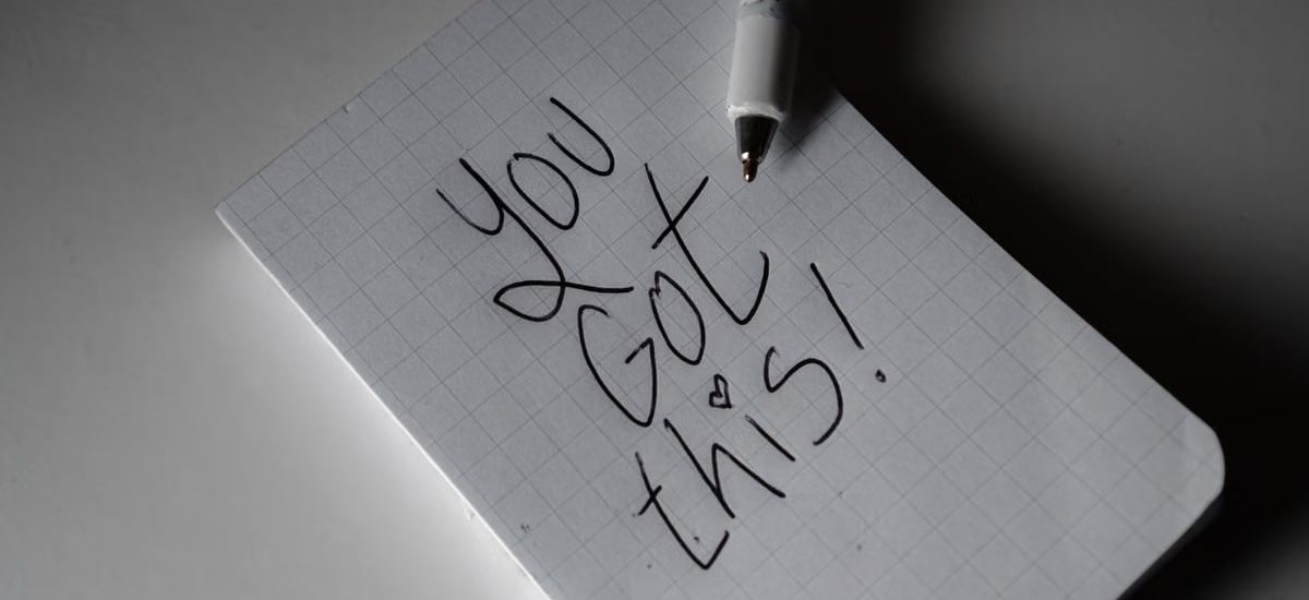 Inspirational handwritten note on graph paper with pen. Encouraging words 'You got this!'