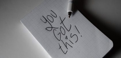 Inspirational handwritten note on graph paper with pen. Encouraging words 'You got this!'