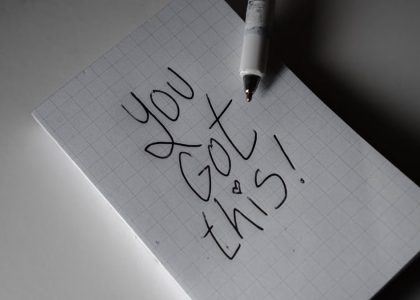 Inspirational handwritten note on graph paper with pen. Encouraging words 'You got this!'